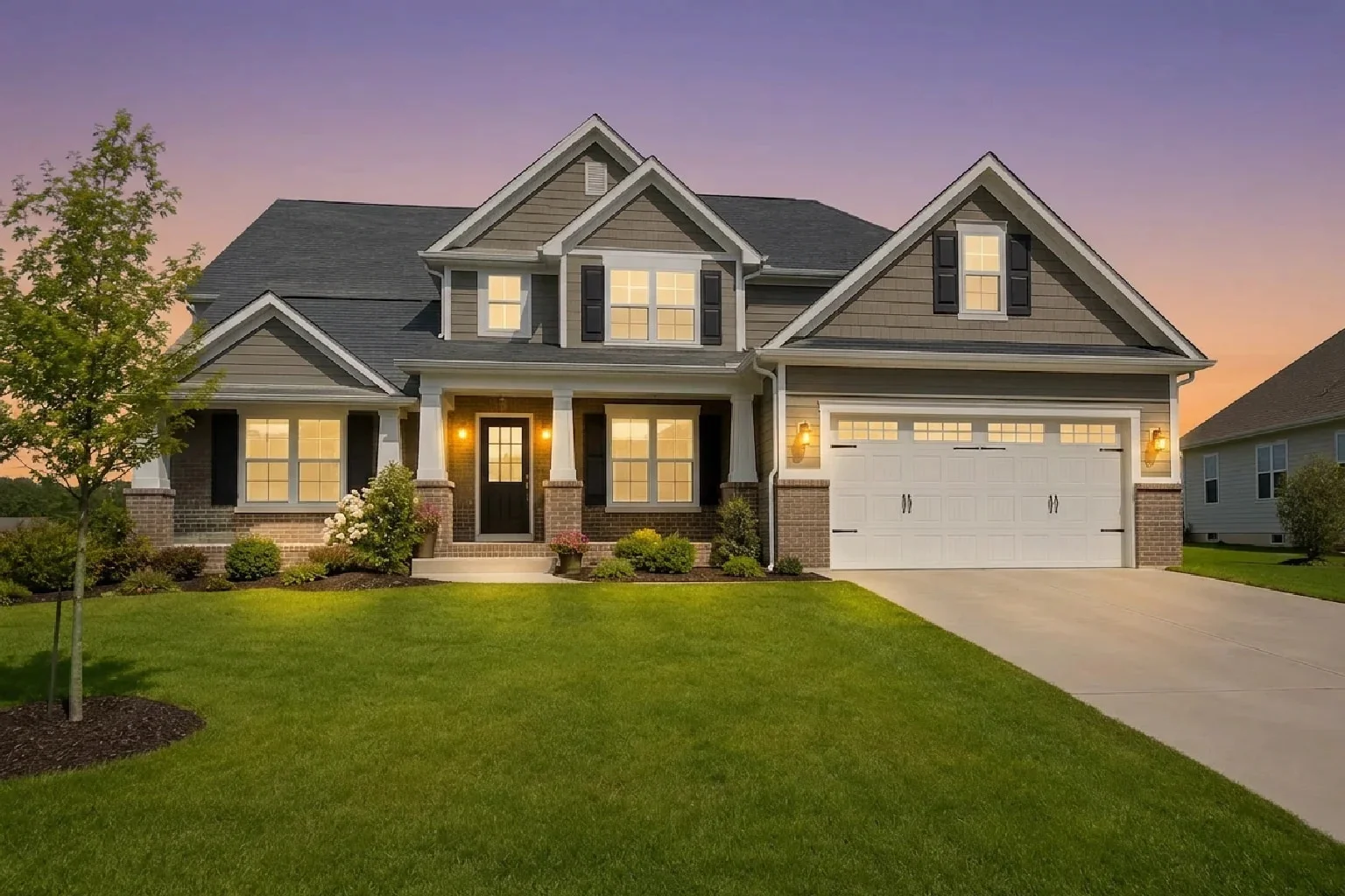 The same exterior at golden dusk: peachy horizon and warm glow